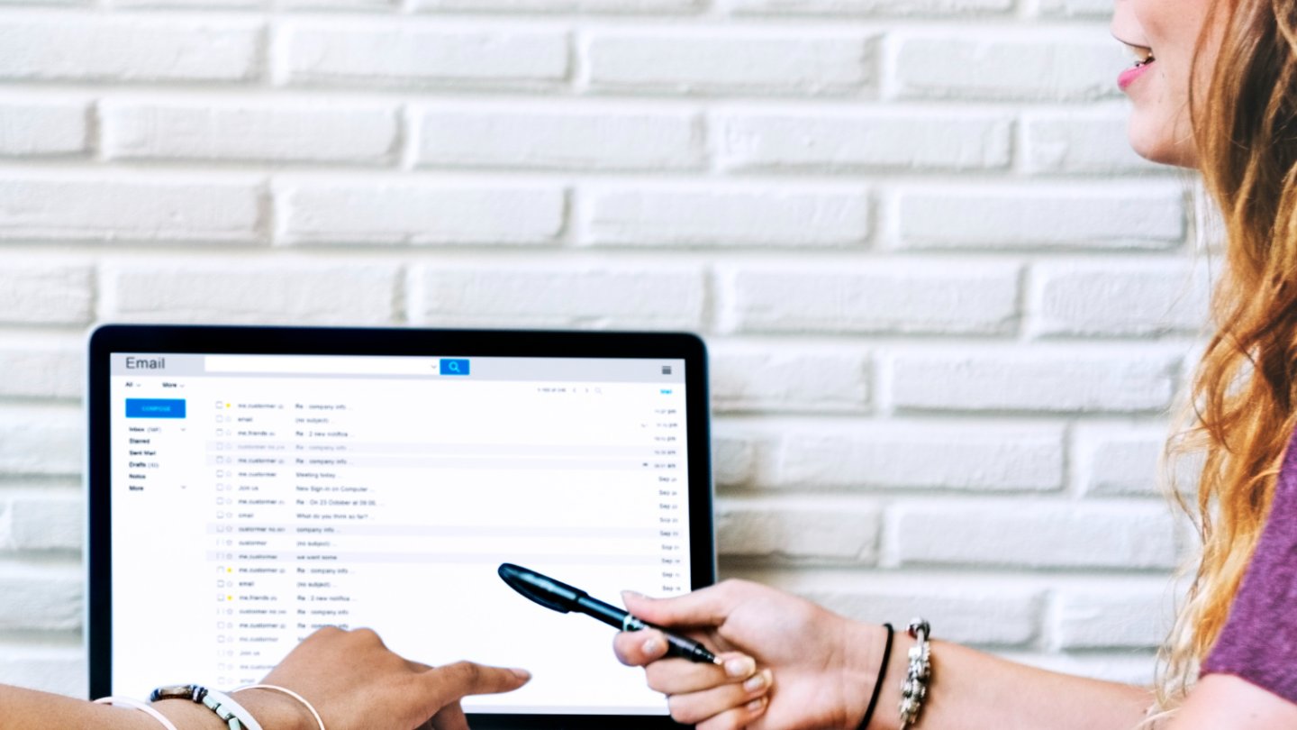 2 women working with laptop together
