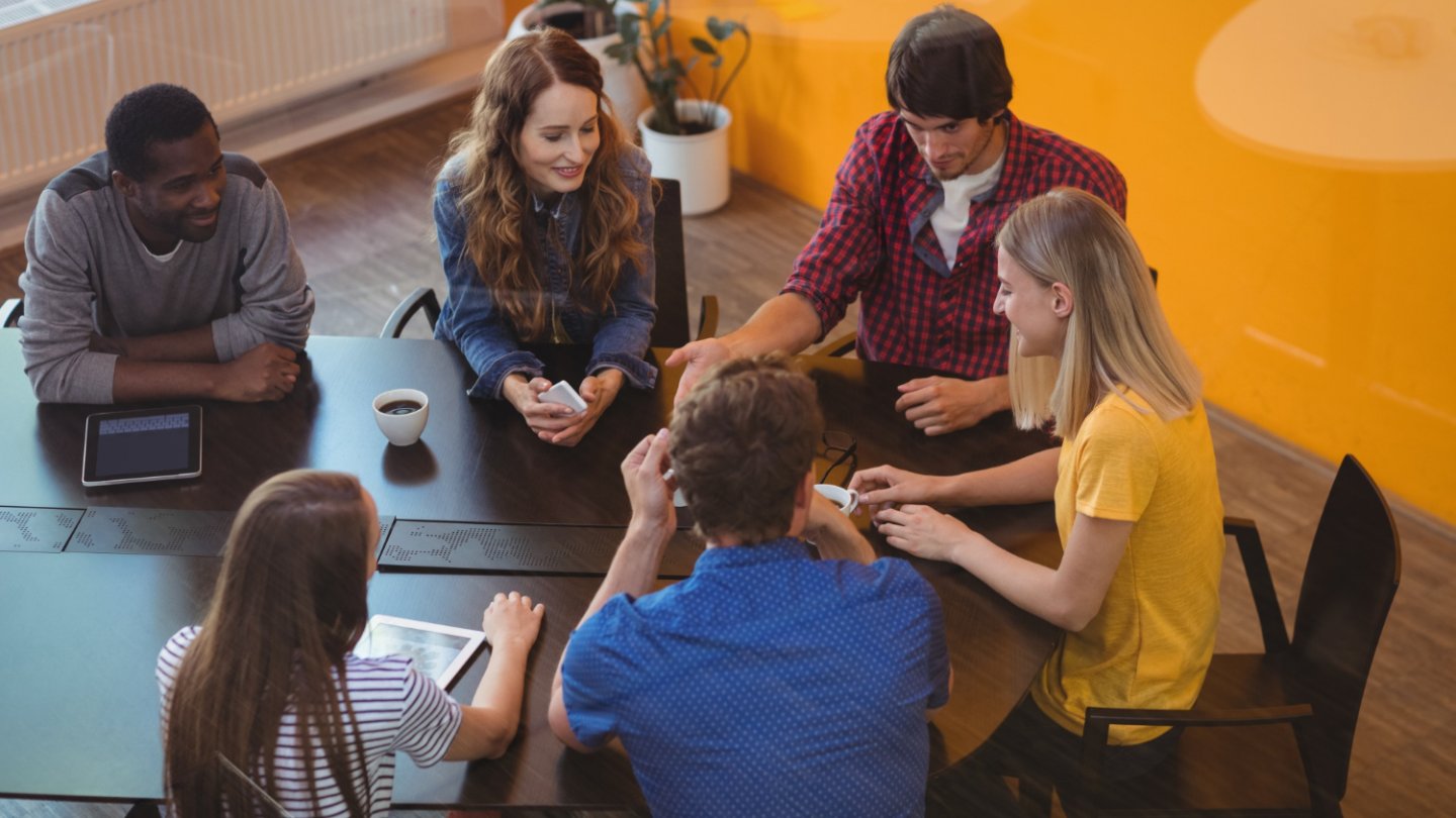 Business executives interacting with each other in office